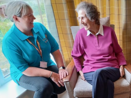 Carer and older lady smiling