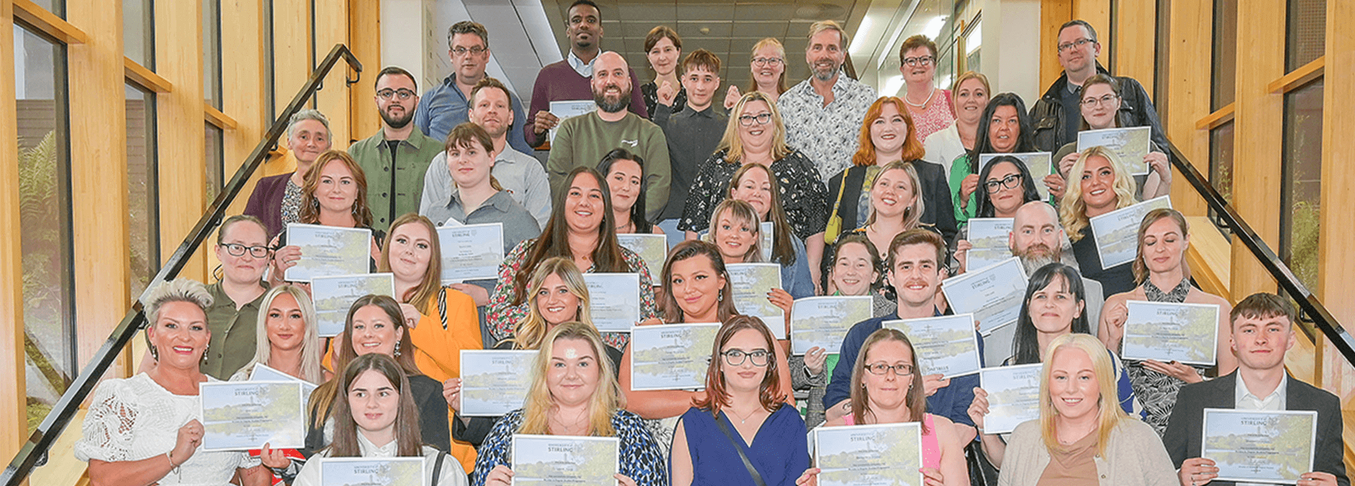 Stirling students standing together with their course completion certificates