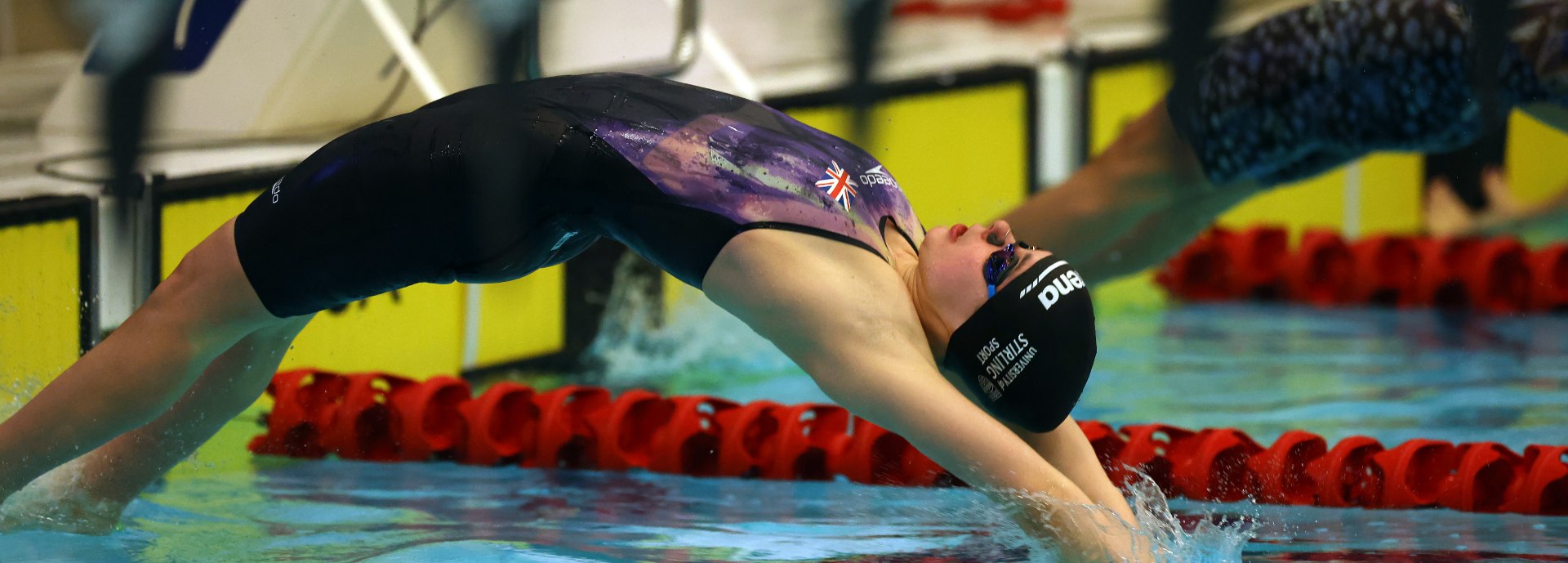 Swimmer Holly McGill dives into the pool.