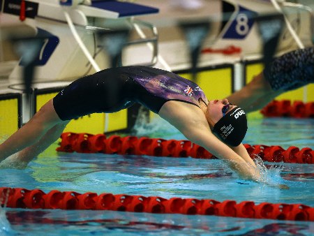 Swimmer Holly McGill dives into the pool.