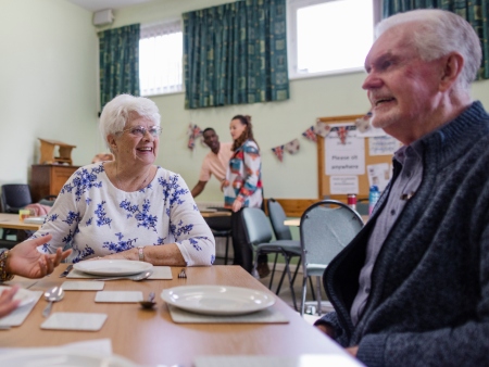 older people and young person talking