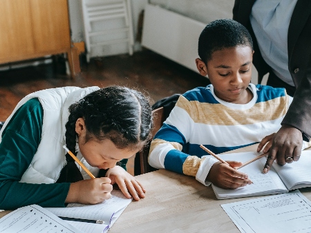 Girl and boy at desk at school