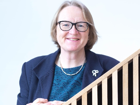 A woman witih glasses on stairs