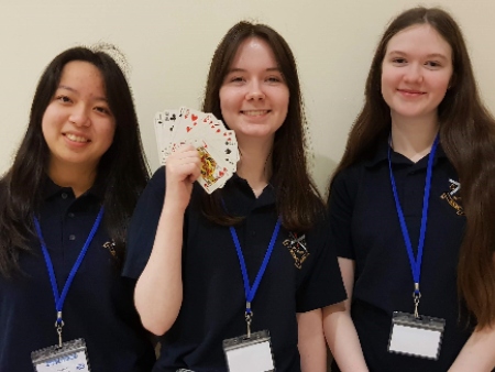 three girls with playing cards