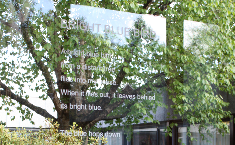 image of words on a window looking out on nature