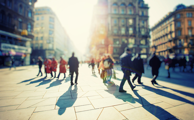 People walking on sunny street