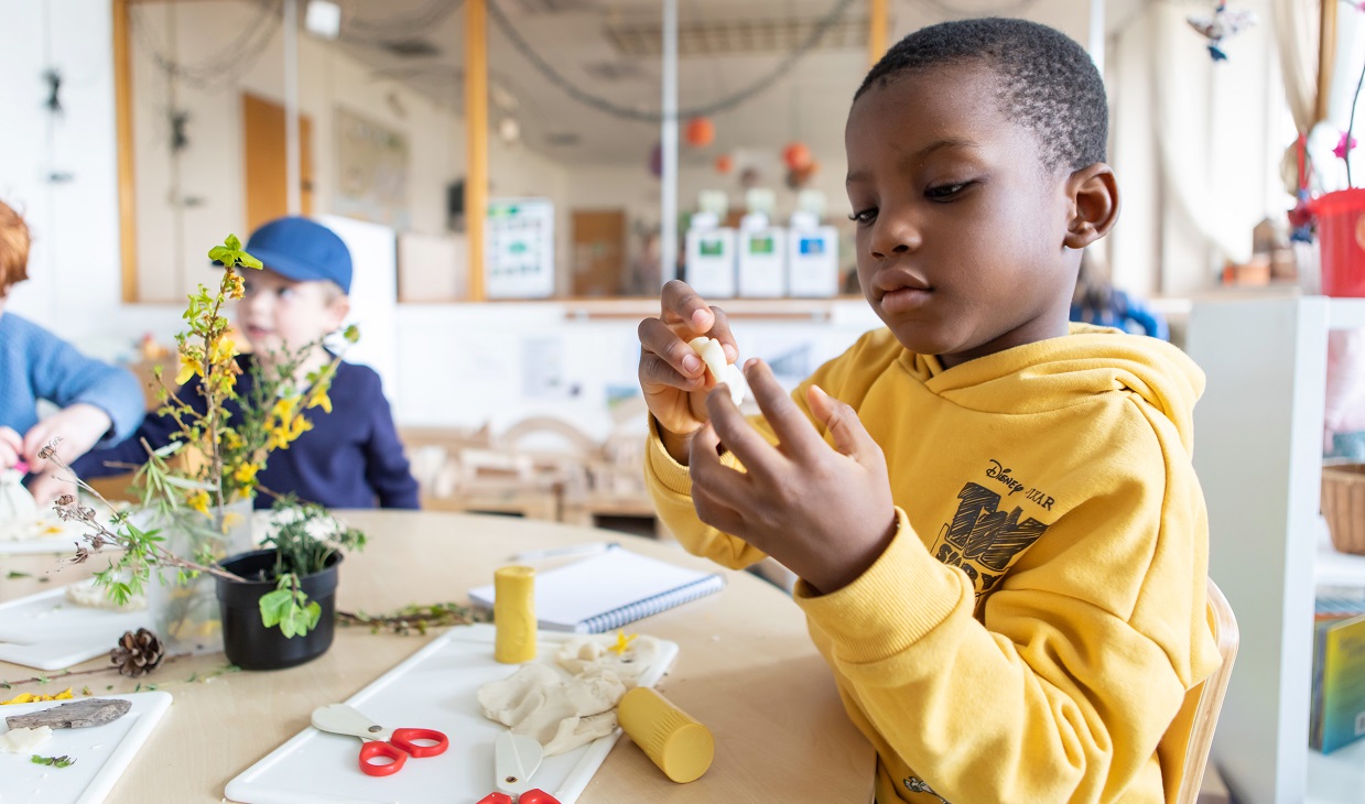 Children making playdough in the kindergarten