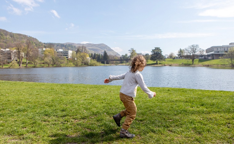 Child playing outdoors on campus