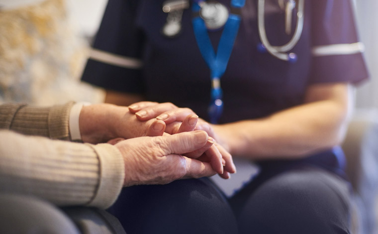 nurse holding patient's hands