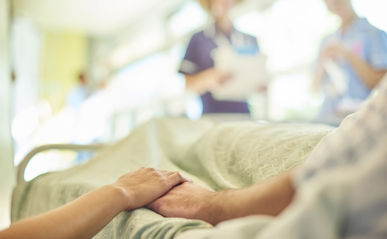 people holding hands in hospital