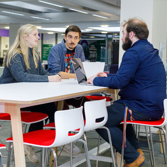 students at table in library