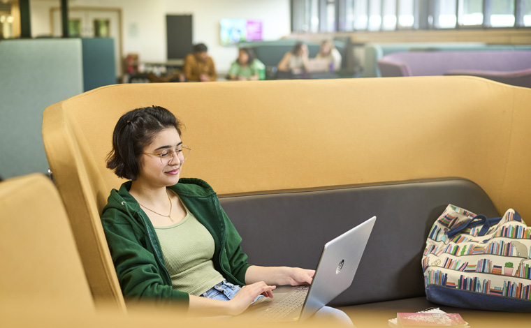 student studying in campus central