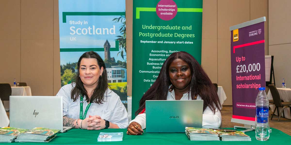 Two university representatives at a desk