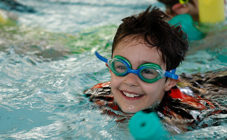 Child enjoying a swimming lesson