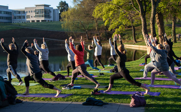 people doing yoga beside university loch